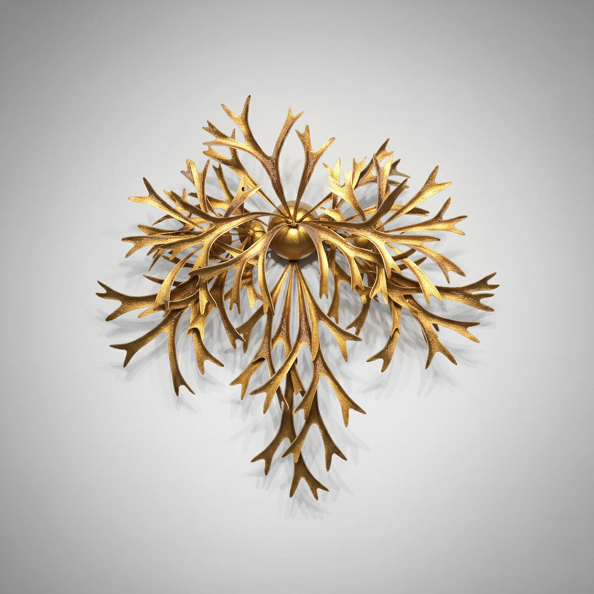 A 30-inch gold metal wall sculpture titled Radial Flora by Marc Staples, featuring textured, antler-like fronds radiating from a central sphere in a biomorphic staghorn fern design.