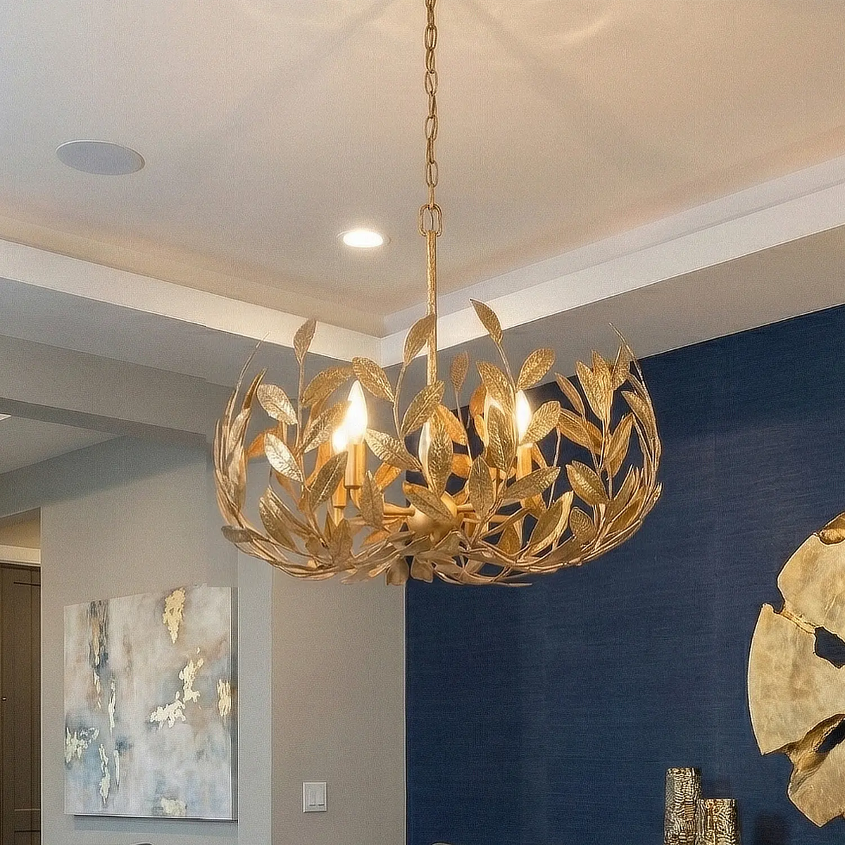 Volado Crown Chandelier in gold over an elegant dining table.