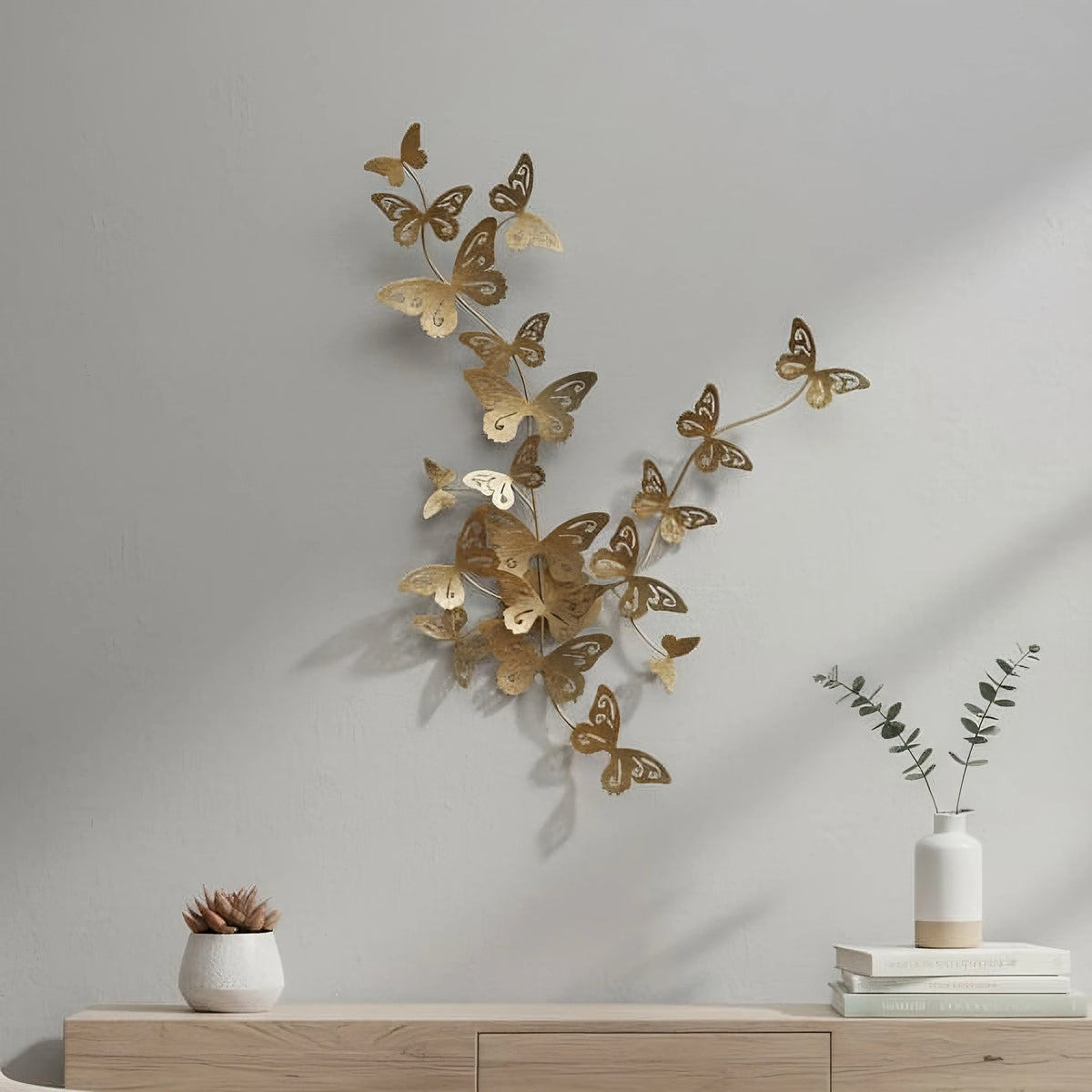 Gold metallic butterfly wall art made of steel, sized 23x30 inches, displayed in a sophisticated living space.
