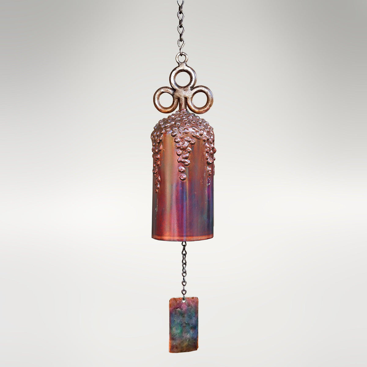 30-inch San Carlos Mission Bell by Marc Staples: A hand-forged steel sound sculpture featuring an intricate grape vine motif and vibrant torched-copper patina.