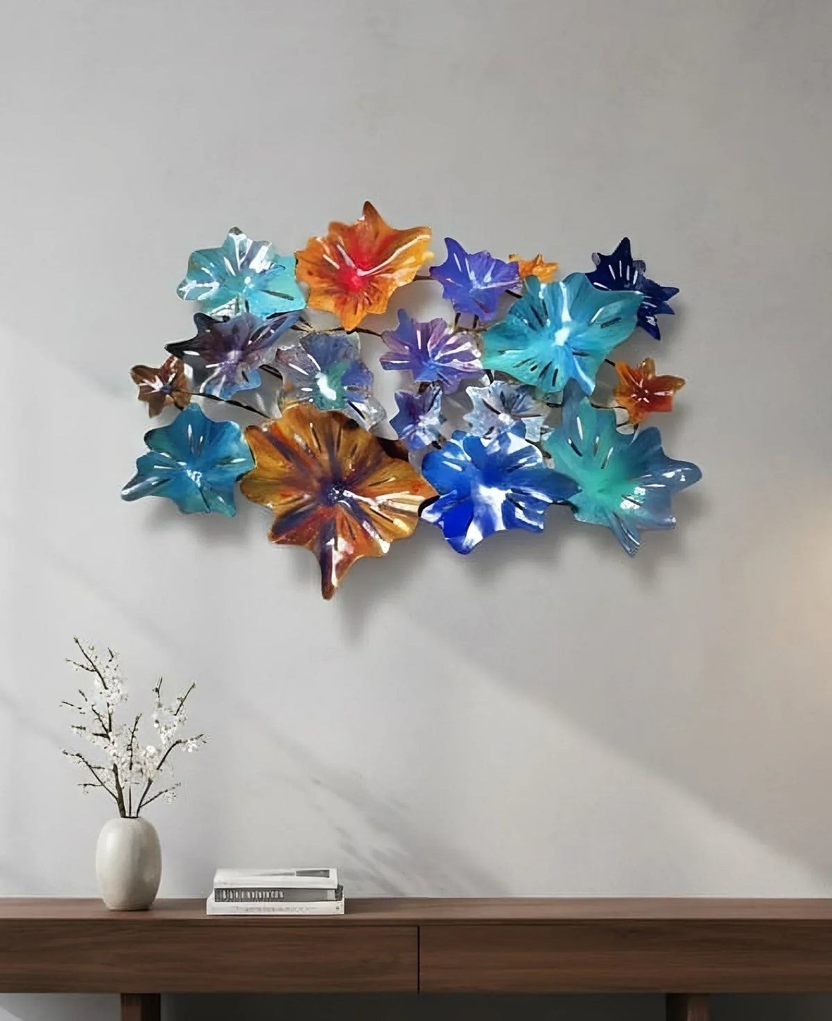 A vibrant metal wall sculpture from Lago Luna Originals hangs on the wall above a sideboard. 