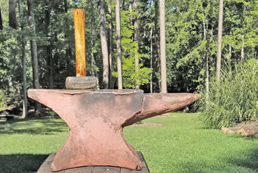 Hammer on an anvil at Lago Luna Studio in Virginia, symbolizing the Artisan’s-Oath and foundational Material-Integrity.