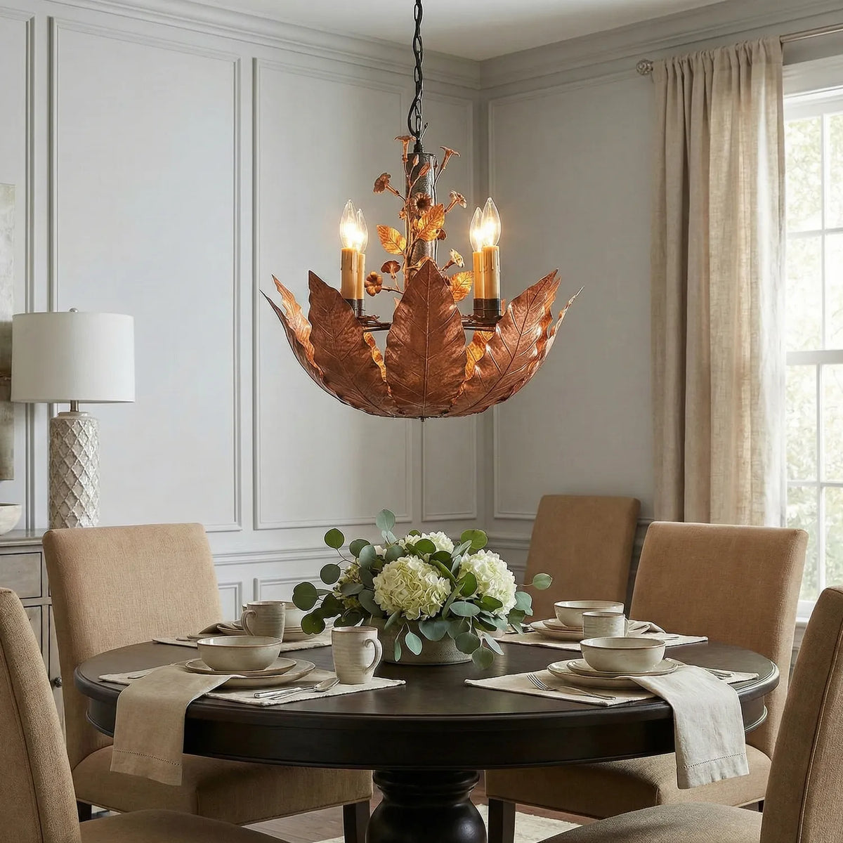 The Aged Burley chandelier by Marc Staples hanging in an elegant dining area. 