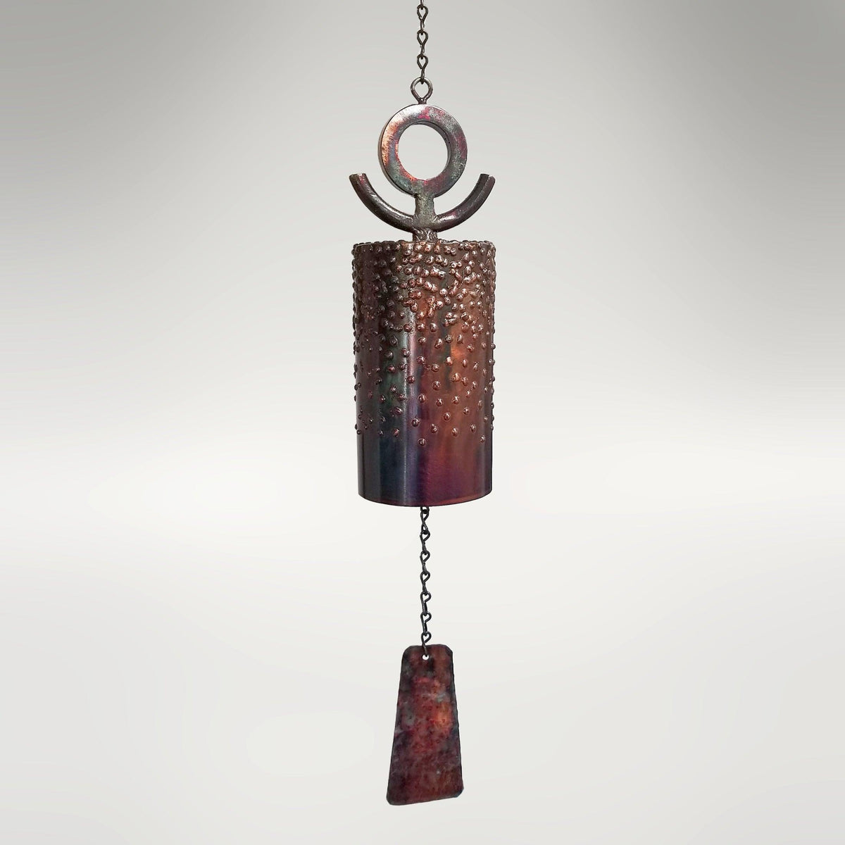 30-inch San Agustin Mission Bell by Marc Staples: A hand-forged steel sound sculpture featuring an intricate grape motif and vibrant torched-copper patina.