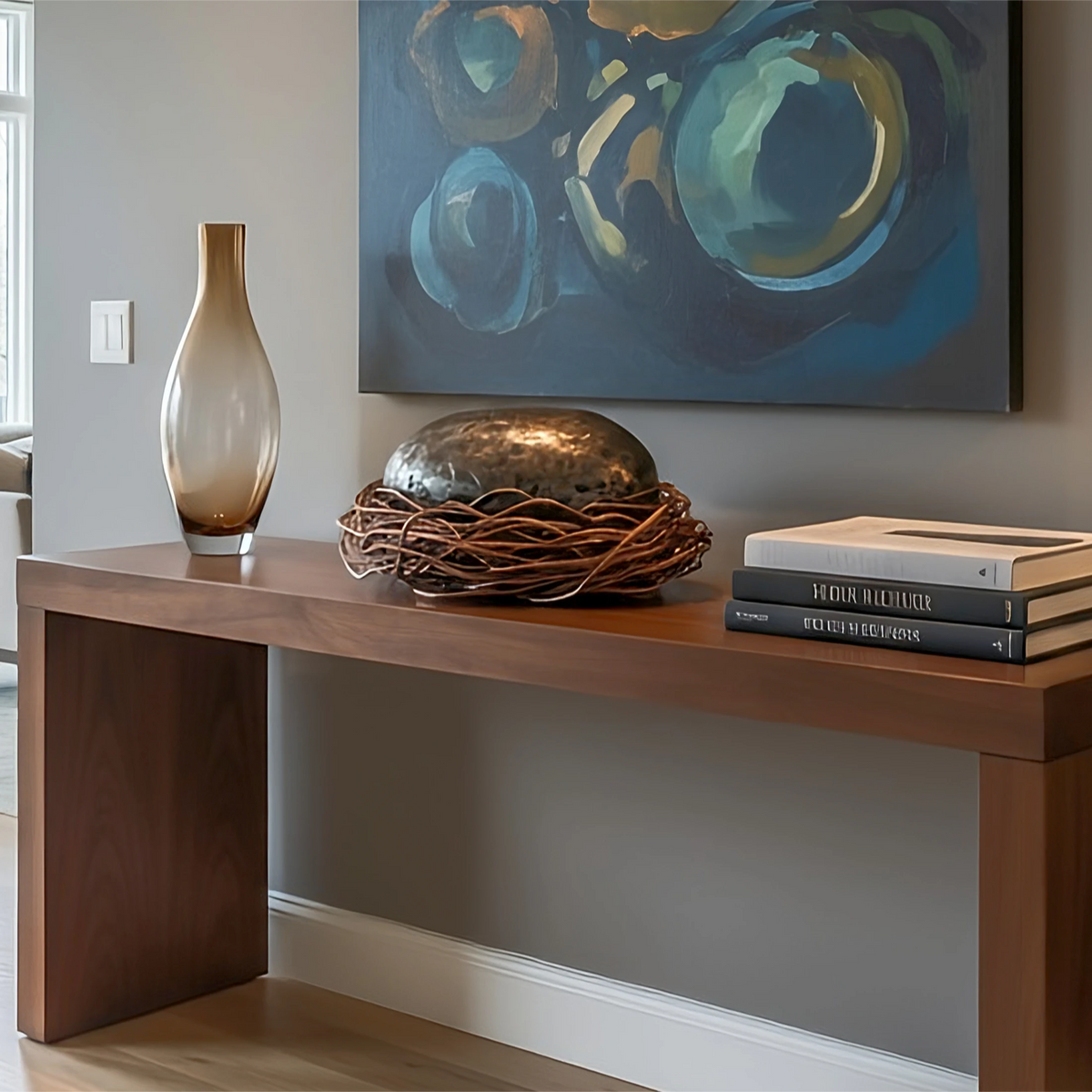 "The Egg" by Marc Staples: A 14-inch wide carbon steel and copper sculpture featuring an iridescent heat-applied patina in blue, gold, and purple tones.