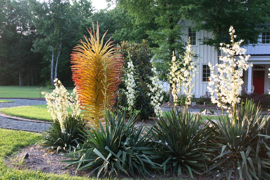 Abstract metal sculpture by the Lago Luna Studio situated in a garden.