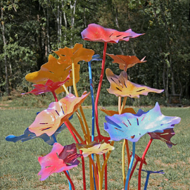 A metal sculpture titled The Dance of Planet Earth installed at Birdland Sculpture Gardens.