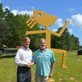 Marc Staples shaking hands with former Virginia Governor Bob McDonnell at the dedication of Marcs sculpture at Powhatan State Park.