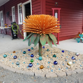 A large and brightly colored steel sculpture named Zinnia. Located at the Lago Luna Metal Art Studio